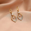 Gold and silver water drop tassel earrings with zircon stones on a copper base.