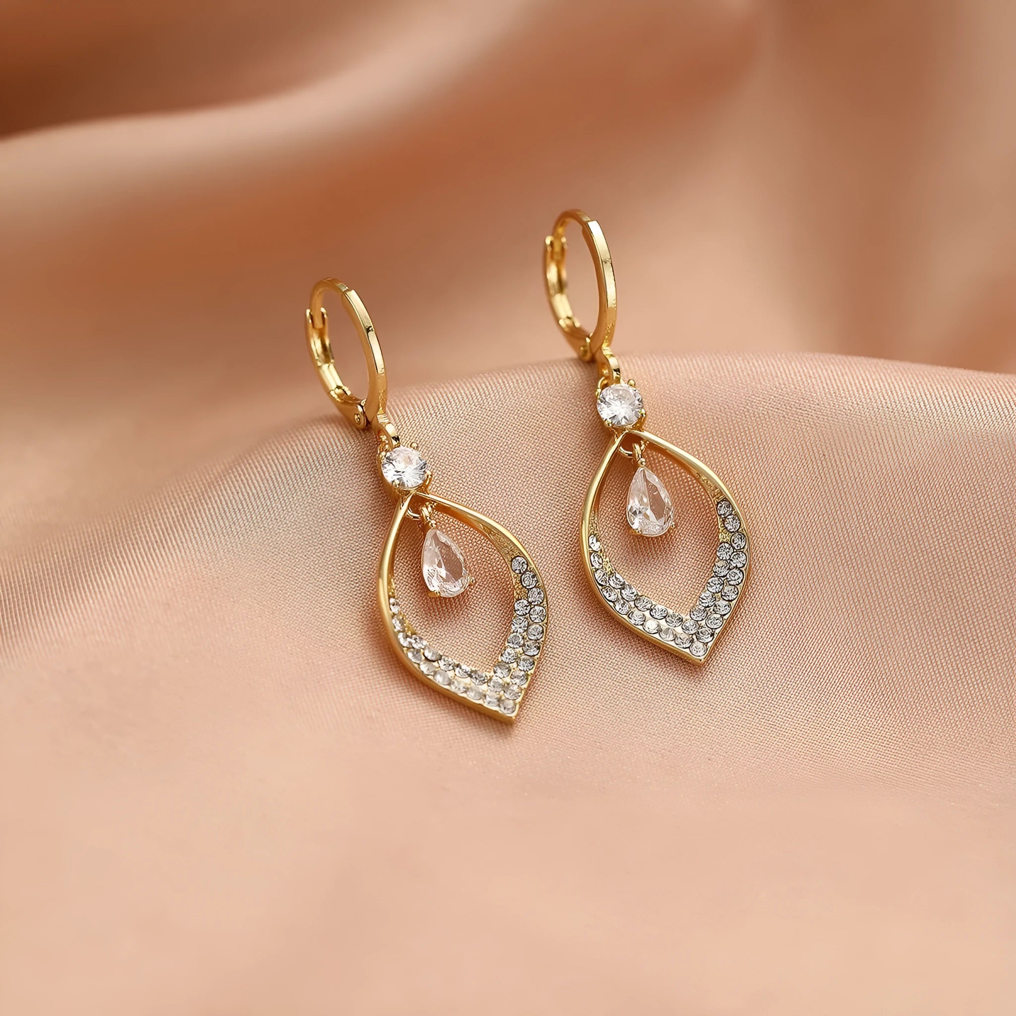 Gold and silver water drop tassel earrings with zircon stones on a copper base.