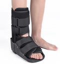 Grey Achilles tendon rehabilitation boot with aluminium side struts and a rubber sole, shown on a foot.
