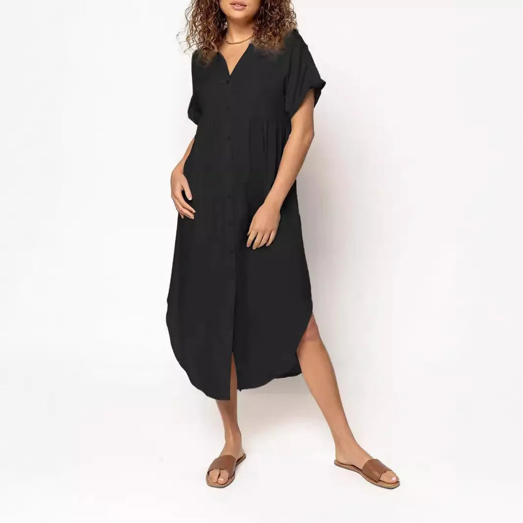 A woman wearing a casual solid-colour mid-length dress with a button-down front.