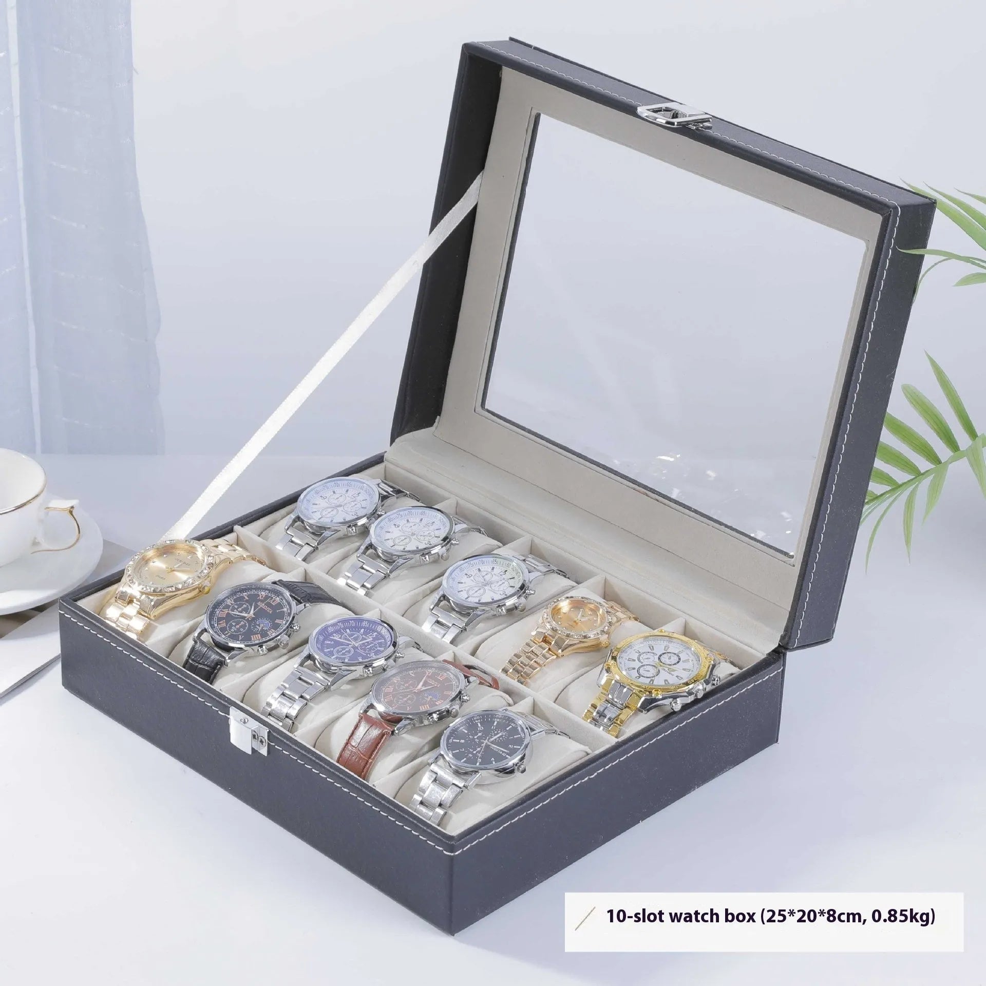 Grey leather watch storage box with clear lid showing watch compartments
