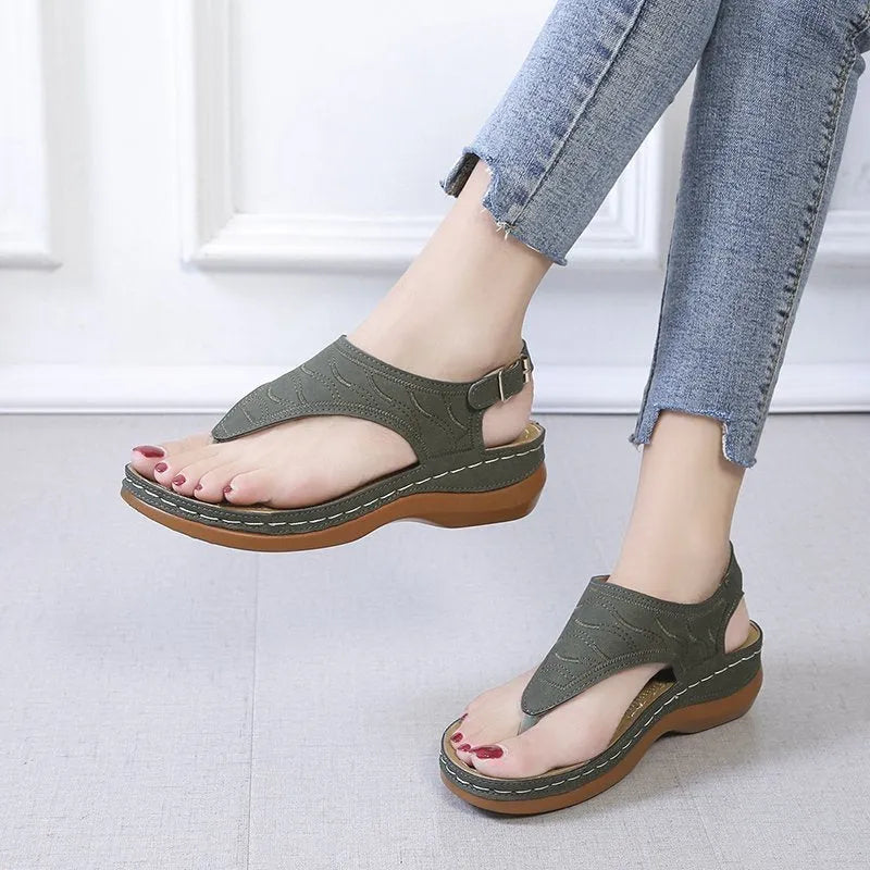Women's casual wedge heel flip flop sandals with an adjustable buckle strap in black.