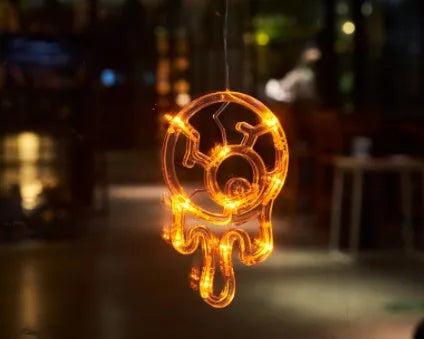 Halloween window hanging LED lights with suction cups showing multiple horror-themed designs powered by batteries