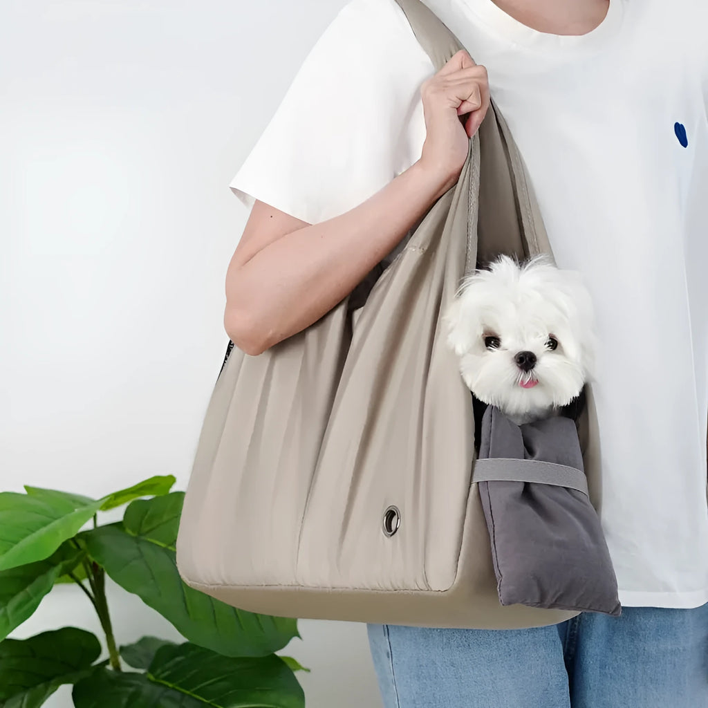 Apricot coloured cloth pet handbag carrier with dimensions 41 cm by 16 cm by 28 cm.