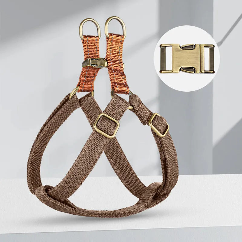 Brown vest-style dog harness on small dog showing cotton belt material and alloy fastener