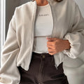 Women's loose-fitting off-shoulder coat with lantern sleeves in brown, showing front view.