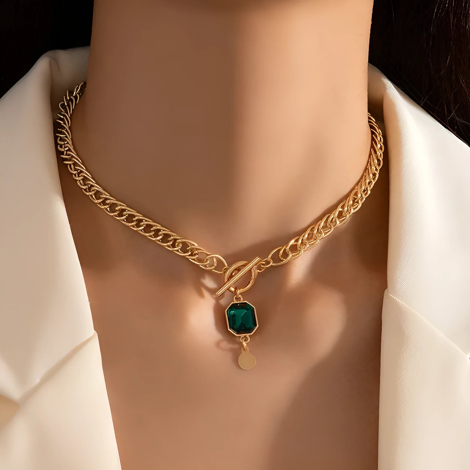 Gold coloured geometric zircon pendant necklace on a Cuban link chain for women.