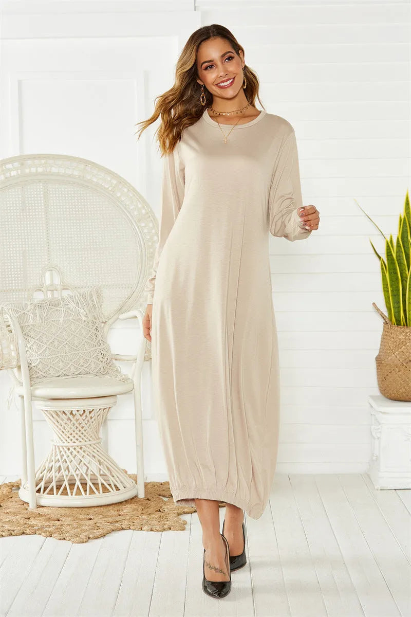 A loose black knitted lantern dress with a lace-up crew neck, showcasing a casual silhouette.