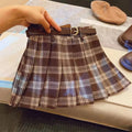 Girls red and black plaid pleated A-line skirt with a cotton lining, shown on a hanger.