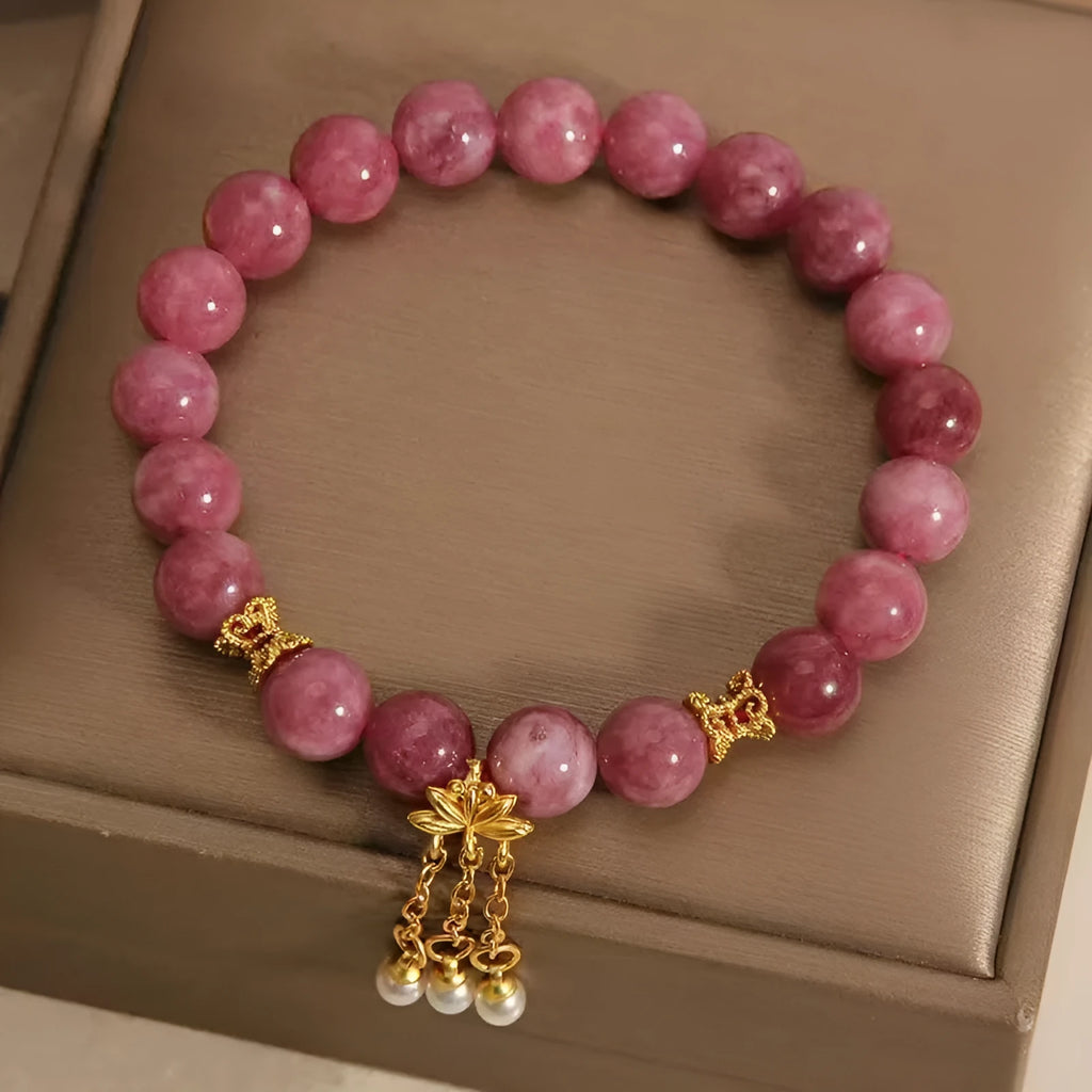 Natural stone bracelet with lotus tassel pendant and pearl details in pink lotus colour