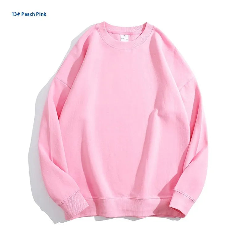 A loose-fitting, off shoulder, round neck cotton sweater in a solid colour with long sleeves.
