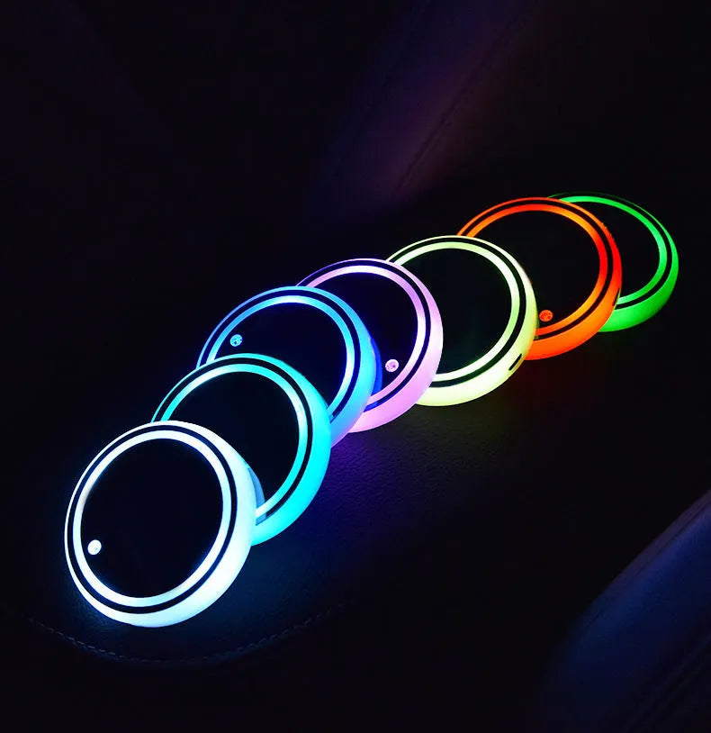 Colourful LED light-up car coaster with solar panel and USB cable on a car seat