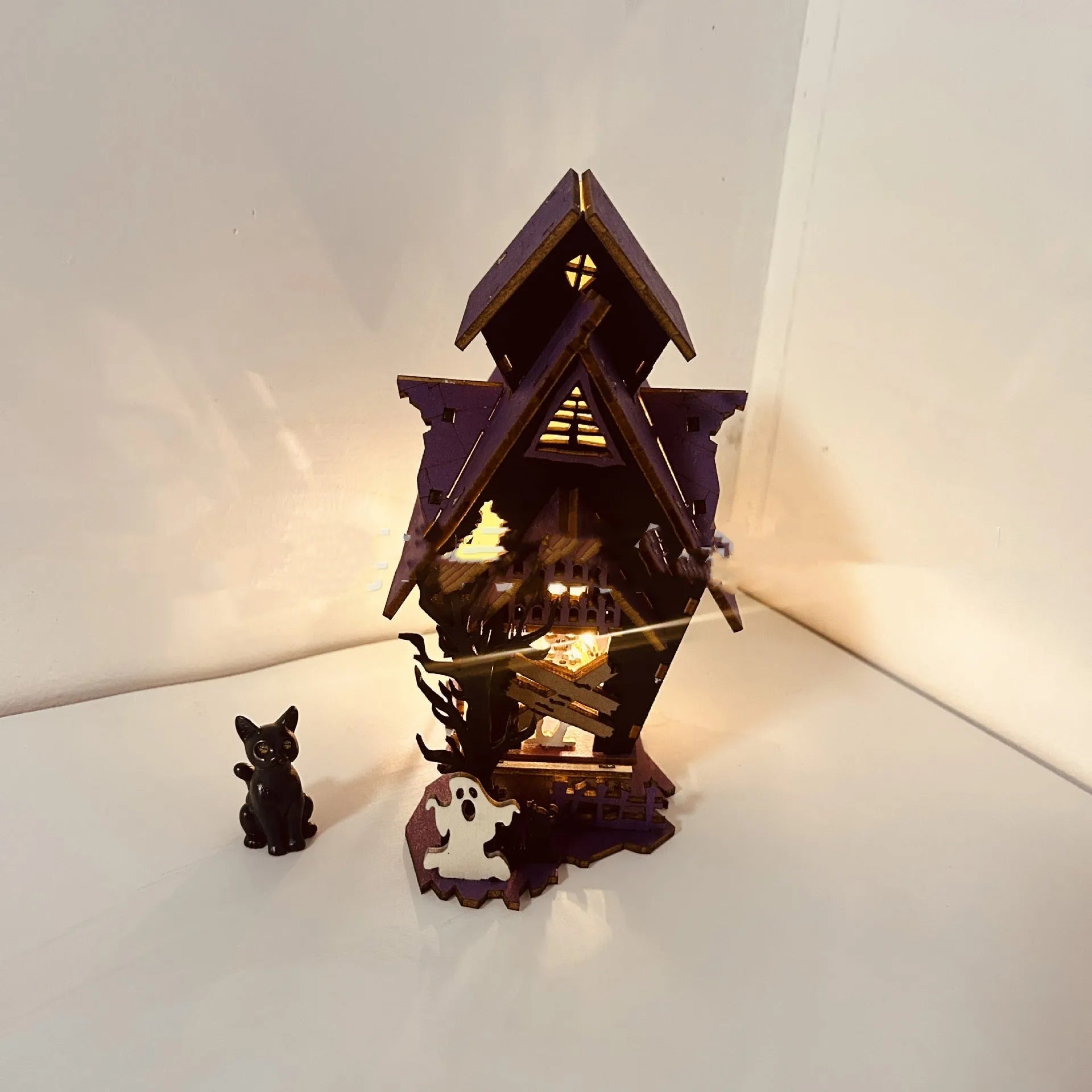 Wooden Halloween haunted house decoration with luminous paint finish, measuring 14x10.5x19cm