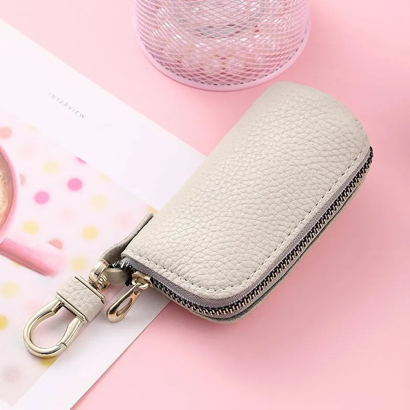 Men's black PU leather zipper key ring organiser case on a grey background.