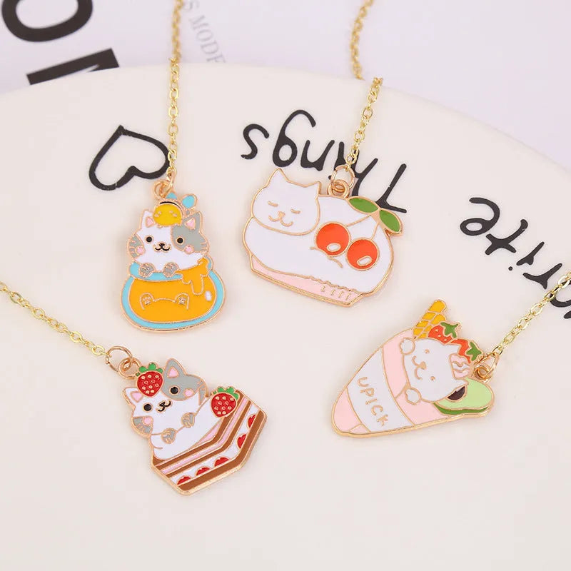 Metal cat pendant bookmark showing one of four cartoon designs: Strawberry Cake, Fruit Roll, Cherry Sleeping, or Yellow Fortune Bag cat.