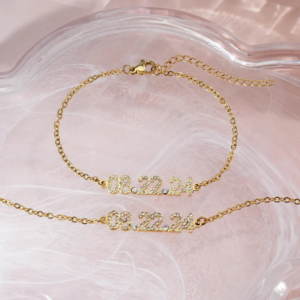 Stainless steel digital bracelet with diamond studded numbers in gold finish.