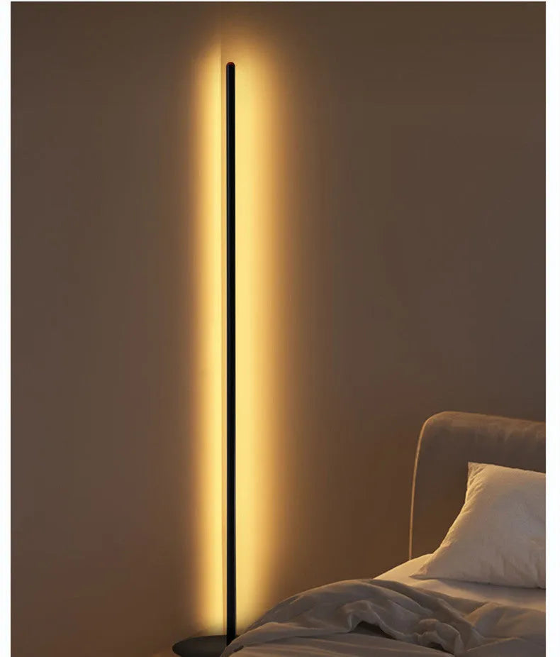 Vertical aluminium alloy floor lamp in modern simple style next to a sofa.