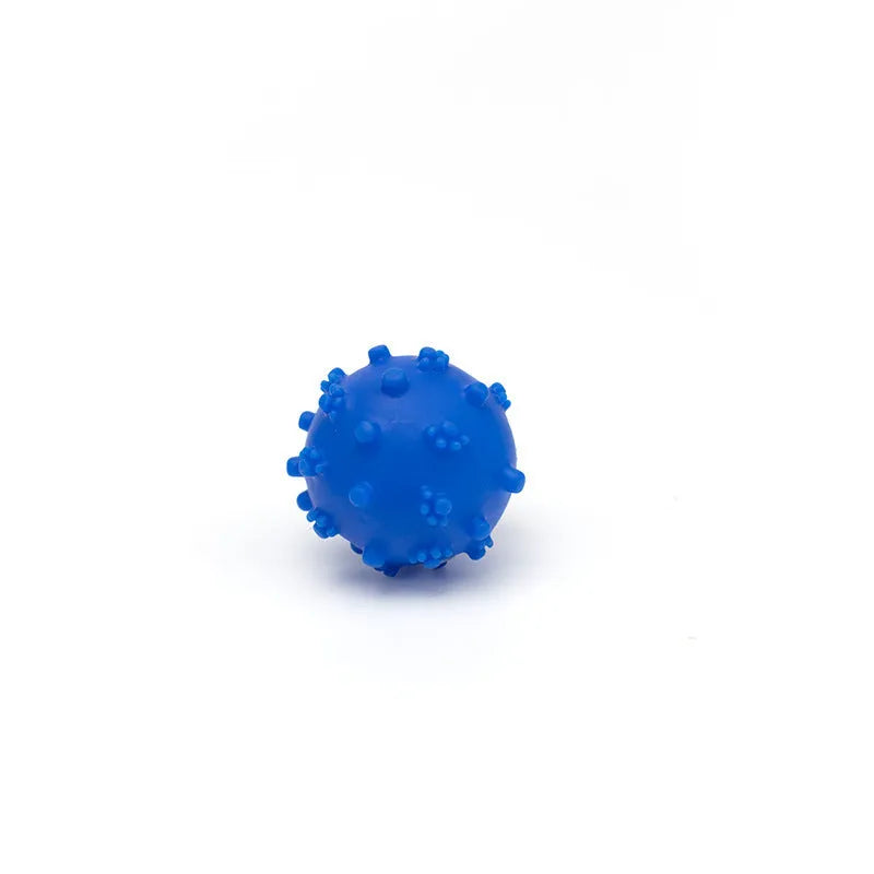 Bright blue, green, pink, and yellow spiked dog toy balls with paw print dimples on a white background.