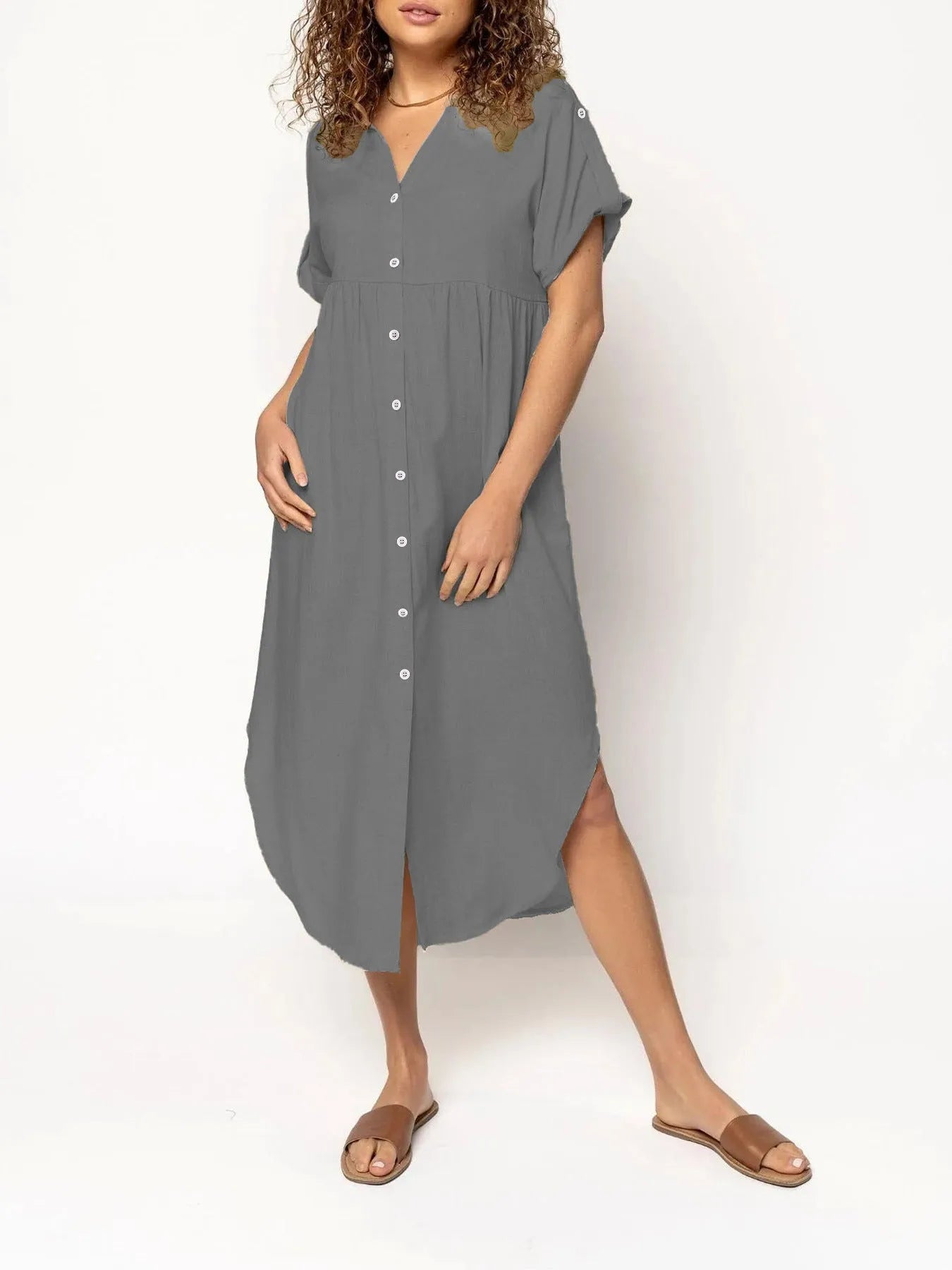 A woman wearing a casual solid-colour mid-length dress with a button-down front.